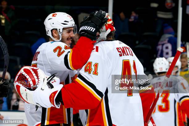 Mike Smith and Travis Hamonic of the Calgary Flames celebrate their teams 3-1 win over the New York Islanders at NYCB Live's Nassau Coliseum on...