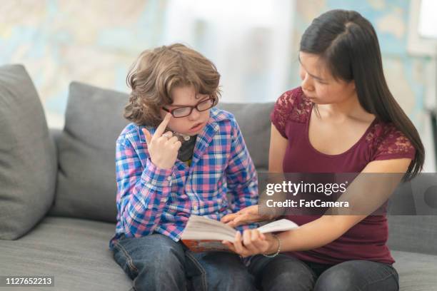 little boy reading - assistive technology student stock pictures, royalty-free photos & images