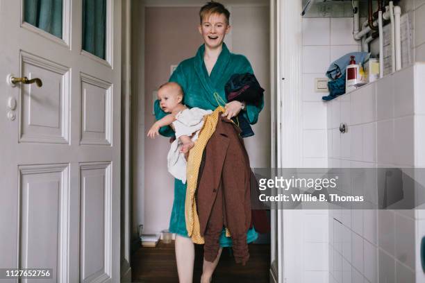Single Mother Carrying Clothes And Baby
