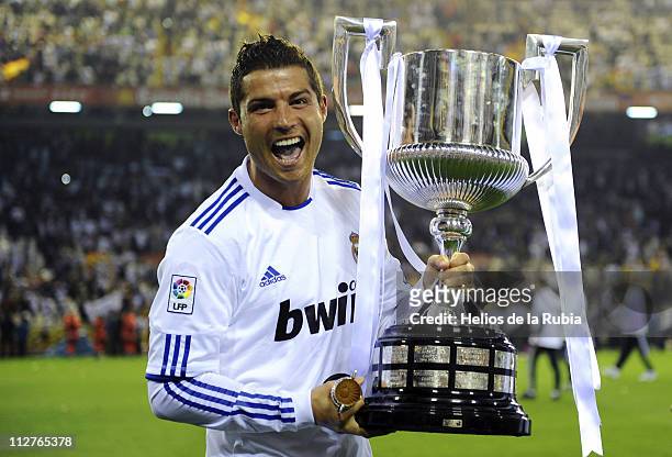 Cristiano Ronaldo of Real Madrid celebrates with the trophy after the Copa del Rey Final between Barcelona and Real Madrid at Estadio Mestalla on...