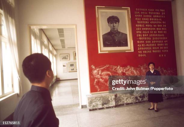 Visitor viewing a portrait of Communist leader Kim Il-sung at the Revolutionary Museum of Culture, Pyongyang, North Korea, February 1973.