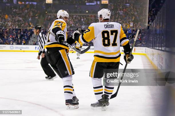 Sidney Crosby of the Pittsburgh Penguins is congratulated by Evgeni Malkin after scoring a goal during the third period of the game against the...