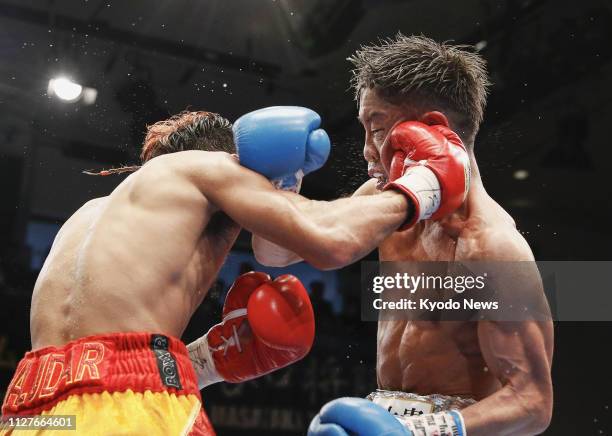 Minimumweight champion Vic Saludar of the Philippines throws a punch at Masataka Taniguchi of Japan during the ninth round of their title match at...