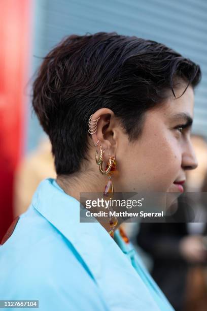 Guest is seen on the street during Men's New York Fashion Week wearing various earrings on February 04, 2019 in New York City.