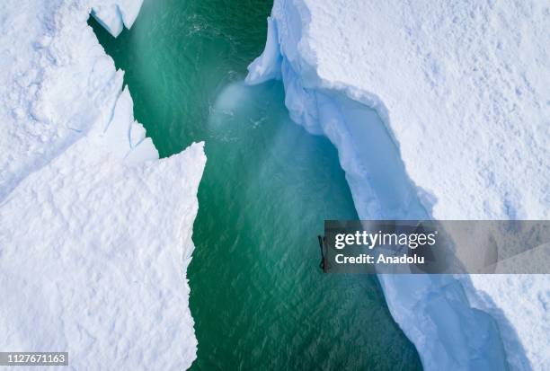 An aerial view of Sahika Ercumen, an internationally renowned Turkish diver, swimming during her free-diving training between the icebergs near...