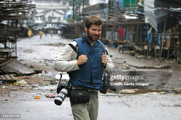 Getty Images photographer Chris Hondros walks through the streets on August 3 in Monrovia, Liberia. Hondros, who was on assignment in Misrata, Libya,...