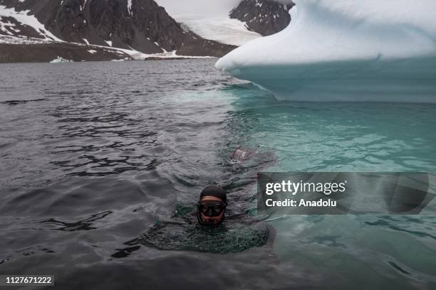 Sahika Ercumen, an internationally renowned Turkish diver, swims near an iceberg during her free-diving, marking the opening of a landmark science...