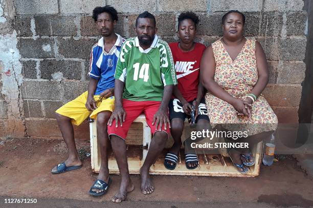 The Voldrin family, which is among Chagossian families exiled from the Chagos islands, poses for a photo on February 26, 2019 in front of their home...