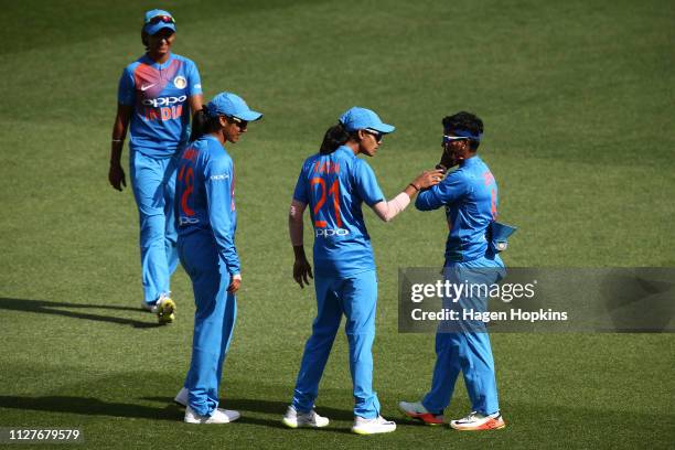 Radha Yadav of India checks on the health of Deepti Sharma of India after colliding with Smriti Mandhana for a catch during game one of the...