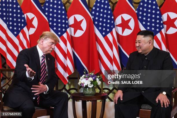President Donald Trump gestures as he speaks with North Korea's leader Kim Jong Un during a meeting at the Sofitel Legend Metropole hotel in Hanoi on...