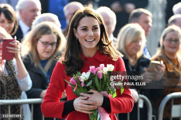 Britain's Catherine, Duchess of Cambridge greets wellwishers as she arrives to visit the Irish Football Association in Belfast, Northern Ireland on...