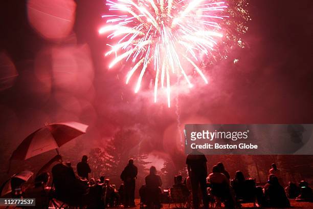 Residents of Madison, NH watch the fireworks spectacle at Burke Field in Madison as part of the 103 Annual Madison Old Home Week. Residents of...