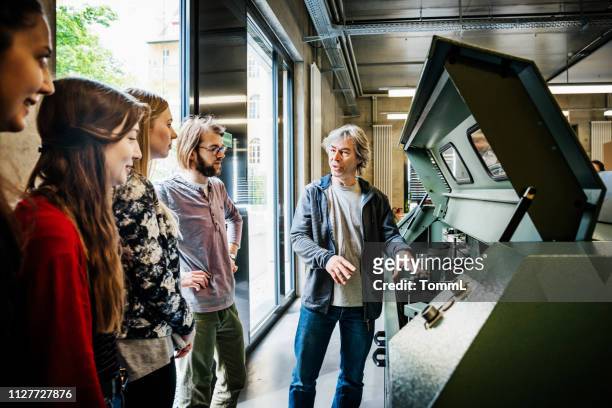 print technician explaining machinery to students - day stock pictures, royalty-free photos & images