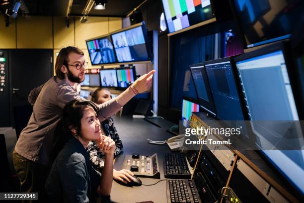 students working in tv studio at university - sala de controlo imagens e fotografias de stock