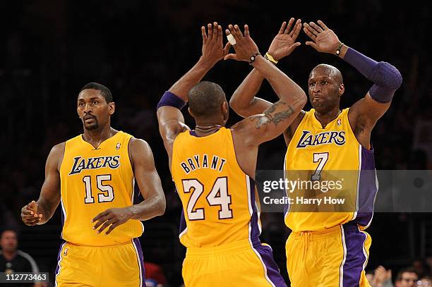 Lamar Odom and Kobe Bryant of the Los Angeles Lakers celebrate on the court as they stand next to teammate Ron Artest while taking on the New Orleans...