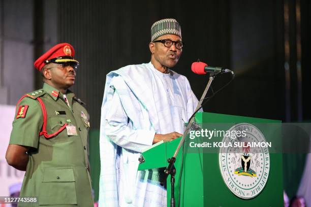 Nigerian President Muhammadu Buhari addresses the audience following his re-election, after Nigeria's Independent National Electoral Commission...