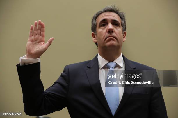 Michael Cohen, former attorney and fixer for President Donald Trump is sworn in before testifying before the House Oversight Committee on Capitol...