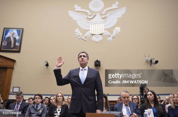 Michael Cohen, US President Donald Trump's former personal attorney, is sworn in to testify before the House Oversight and Reform Committee in the...