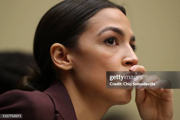 Rep. Alexandria Ocasio-Cortez listens to testimony by Michael Cohen, former attorney and fixer for President Donald Trump, before the House Oversight...