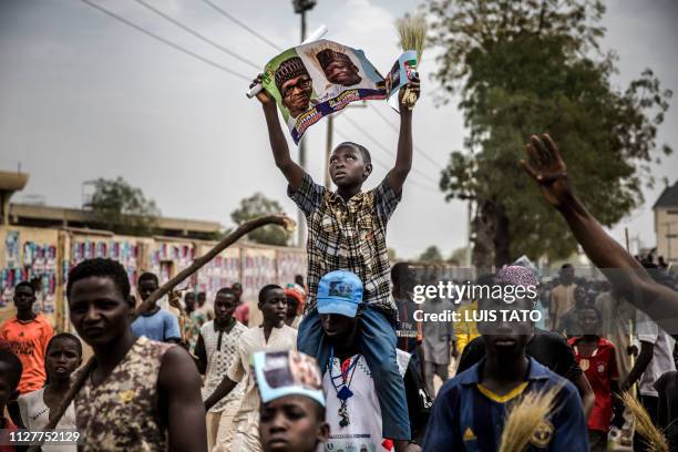 All Progressives Congress party supporters rally as they celebrate the re-election of the incumbent president and the leader of APC, in Kano on...