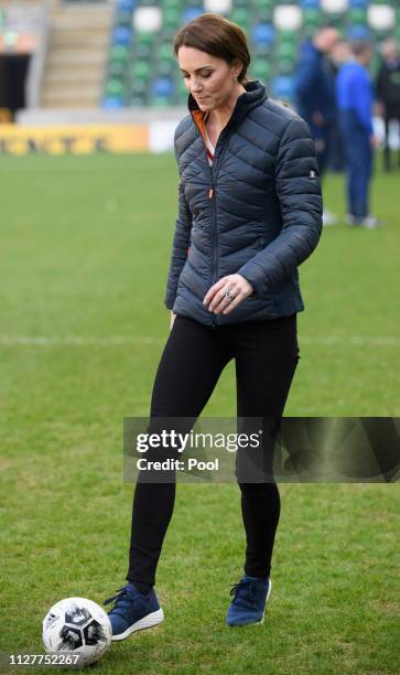 Catherine, Duchess of Cambridge takes part in a football training session with children during a visit the National Stadium in Belfast, home of the...