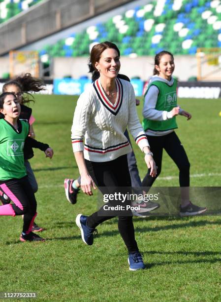 Catherine, Duchess of Cambridge takes part in a football training session with children during a visit the National Stadium in Belfast, home of the...