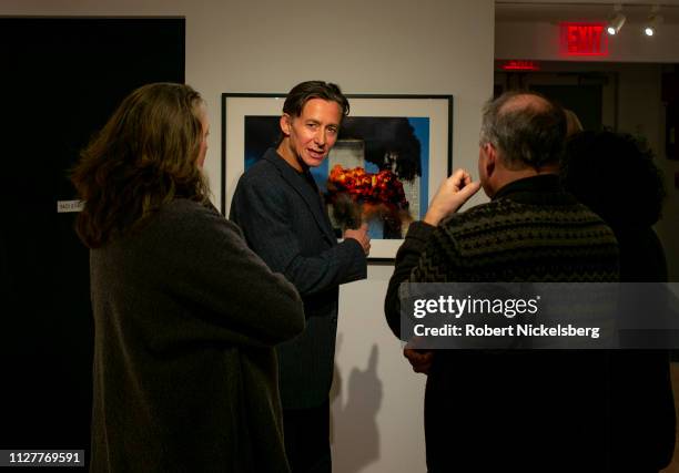 Getty Images photographer Spencer Platt, center, speaks with local residents about an image he took of the 9-11 attack on the World Trade Center...
