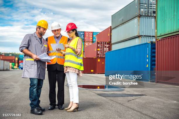 port workers checking cargo containers - dock worker stock pictures, royalty-free photos & images