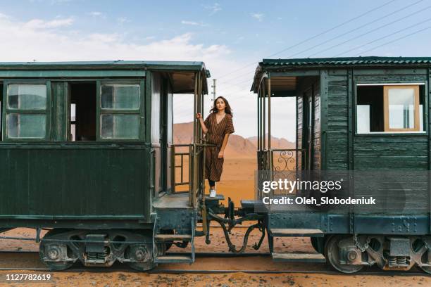 Woman standing between wagons  in old-fashioned train