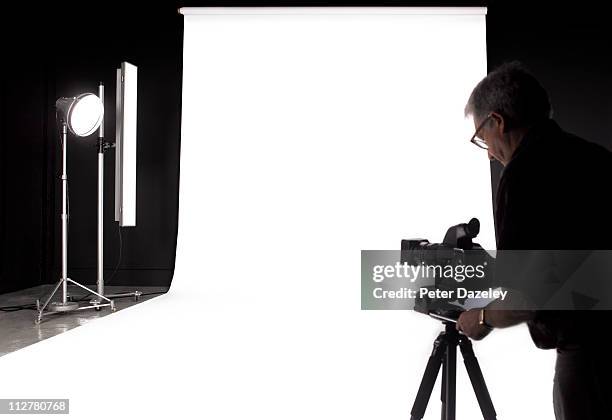 photographer setting up digital camera in studio - photo shoot studio bildbanksfoton och bilder