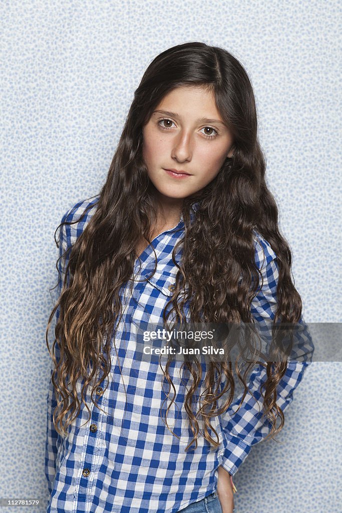 Girl (11-12) in blue plaid shirt, portrait