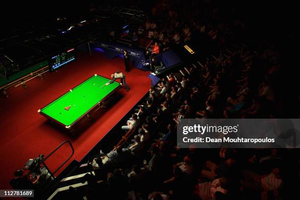 Martin Gould of England plays a shot in the round two game against Judd Trump of England on day six of the Betfred.com World Snooker Championship at...