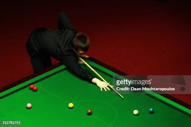 Judd Trump of England plays a shot in the round two game against Martin Gould of England on day six of the Betfred.com World Snooker Championship at...