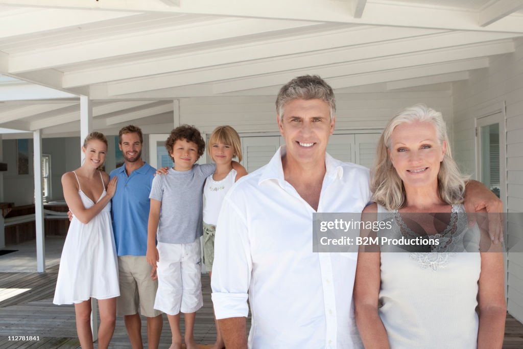 Family standing together with hand on shoulder