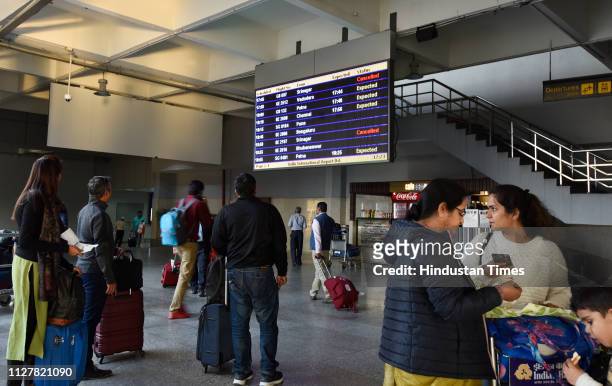 Passengers in front of the schedule board at Terminal 2, Indira Gandhi International Airport after the air space restrictions following tensions...