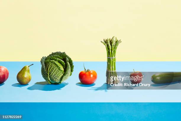 a row of different fruit and vegetables - frische stock-fotos und bilder