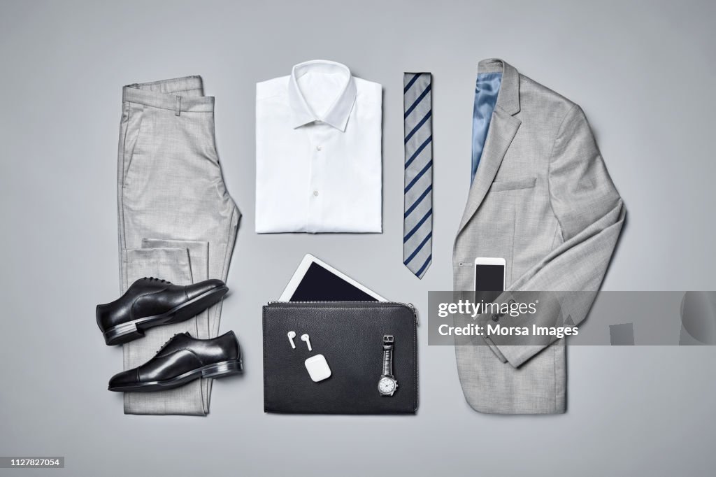 Formalwear arranged on gray background