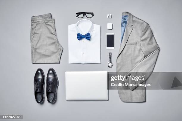 businesswear arranged on gray background - pantalón gris fotografías e imágenes de stock