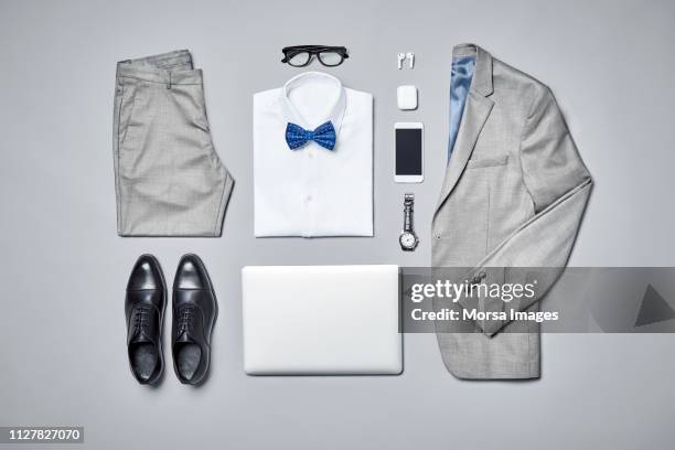 businesswear arranged on gray background - grey shoe photos et images de collection