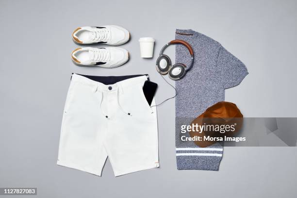 menswear with personal accessories and technologies - gray shorts stockfoto's en -beelden