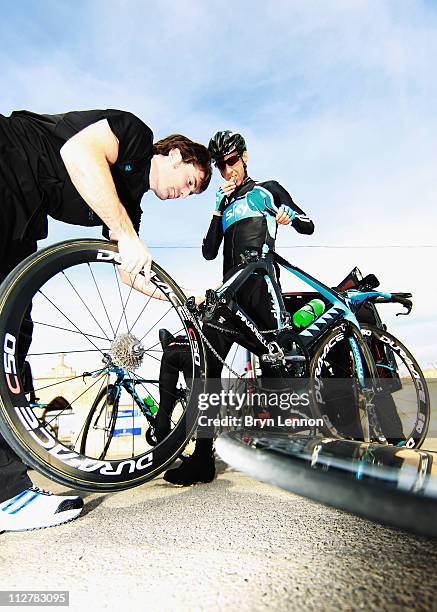 Kurt-Asle Arevesen of Norway receives a wheel change during a SKY Procycling team training camp in Puerto Alcudia, on January 19, 2011 in Mallorca,...