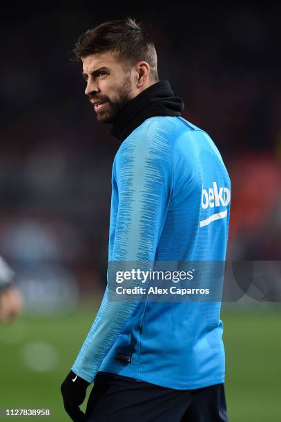 Gerard Pique of FC Barcelona looks on during the warm up prior to the Copa del Semi Final first leg match between Barcelona and Real Madrid at Nou...