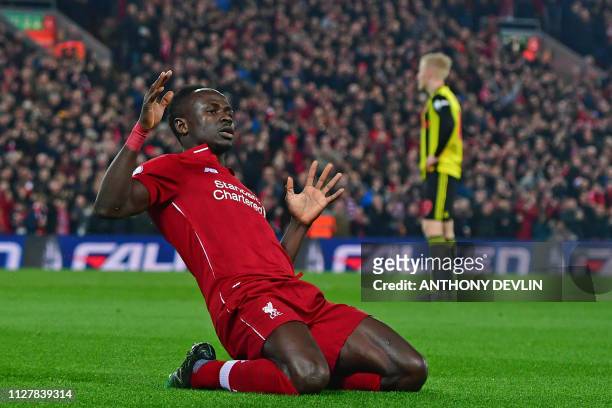 Liverpool's Senegalese striker Sadio Mane celebrates after scoring the opening goal of the English Premier League football match between Liverpool...