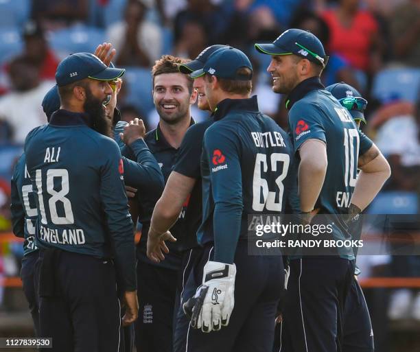 Mark Wood of England celebrates the dismissal of Darren Bravo of West Indies during the 4th ODI between West Indies and England at Grenada National...