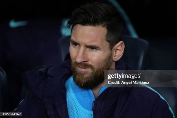 Lionel Messi of FC Barcelona looks on from the bench during the Copa del Semi Final first leg match between Barcelona and Real Madrid at Nou Camp on...