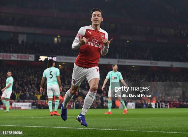 Mesut Ozil celebrates scoring a goal for Arsenal during the Premier League match between Arsenal FC and AFC Bournemouth at Emirates Stadium on...