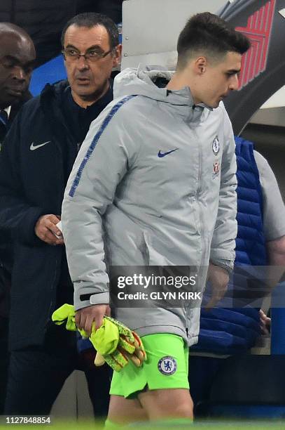 Chelsea's Italian head coach Maurizio Sarri and Chelsea's Spanish goalkeeper Kepa Arrizabalaga arrive back on the pitch after half-time during the...