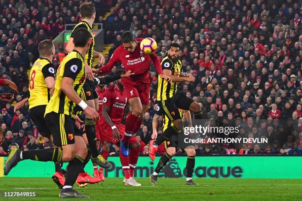 Liverpool's Dutch defender Virgil van Dijk heads home their fourth goal during the English Premier League football match between Liverpool and...