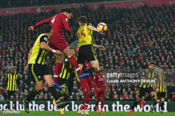 Liverpool's Dutch defender Virgil van Dijk heads home their fifth goal during the English Premier League football match between Liverpool and Watford...