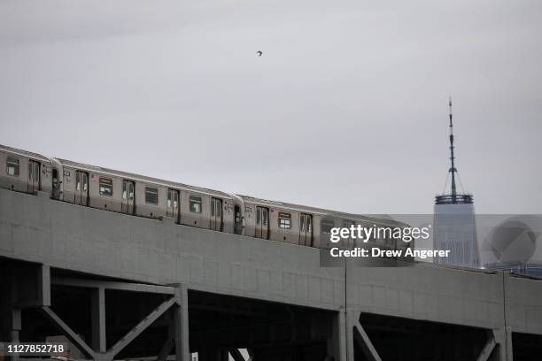 With One World Trade Center behind it, a subway train moves along the F/G line in Brooklyn, February 27, 2019 in New York City. On Wednesday, the...